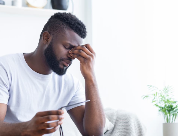 Man suffering from headache drinking hot tea